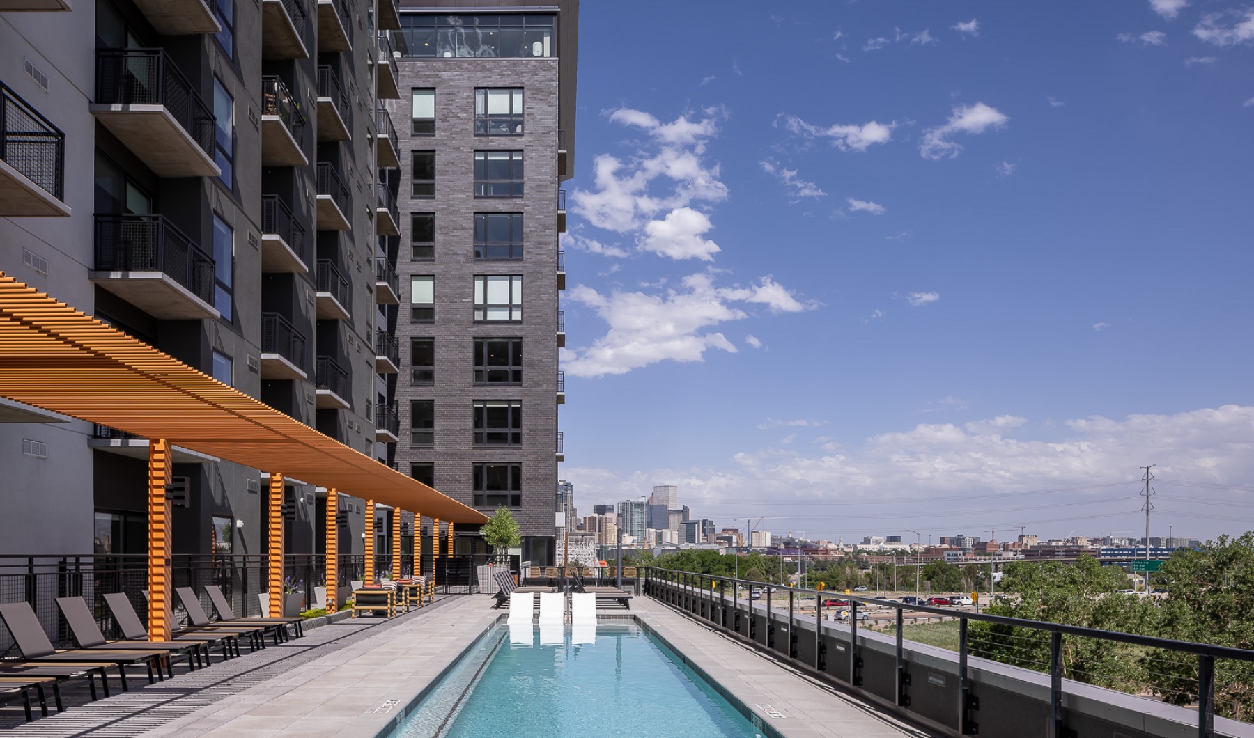 Outdoor pool deck with view of downtwon