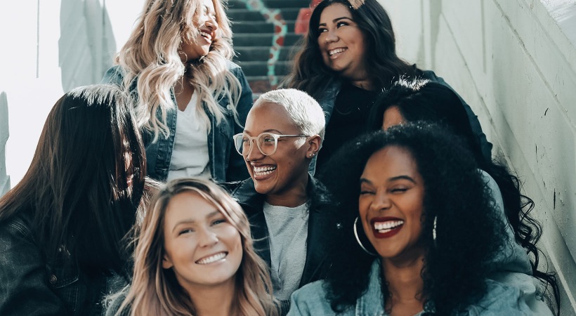 women sitting on stairway laughing and having fun